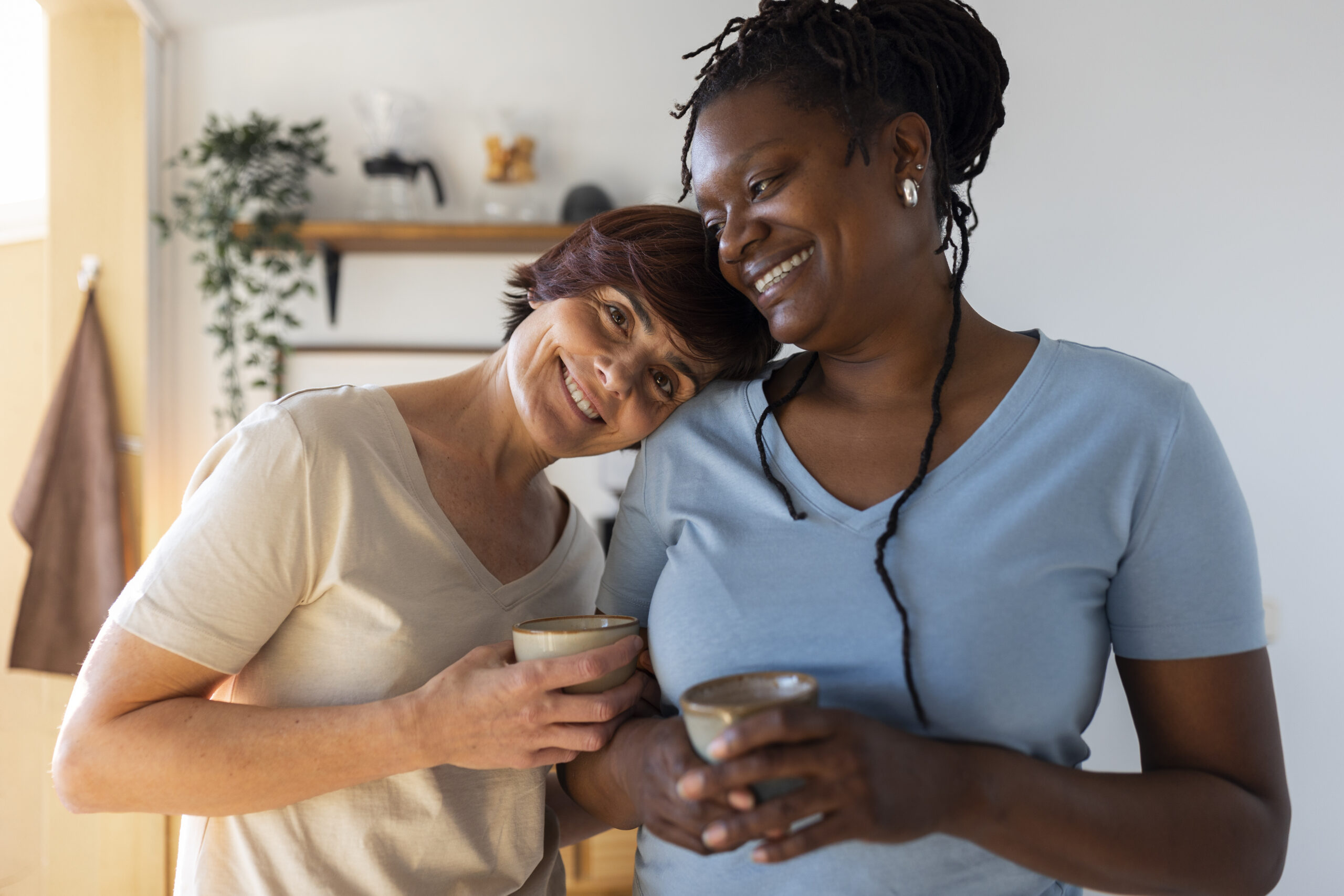 front view lesbian couple with coffee cups scaled